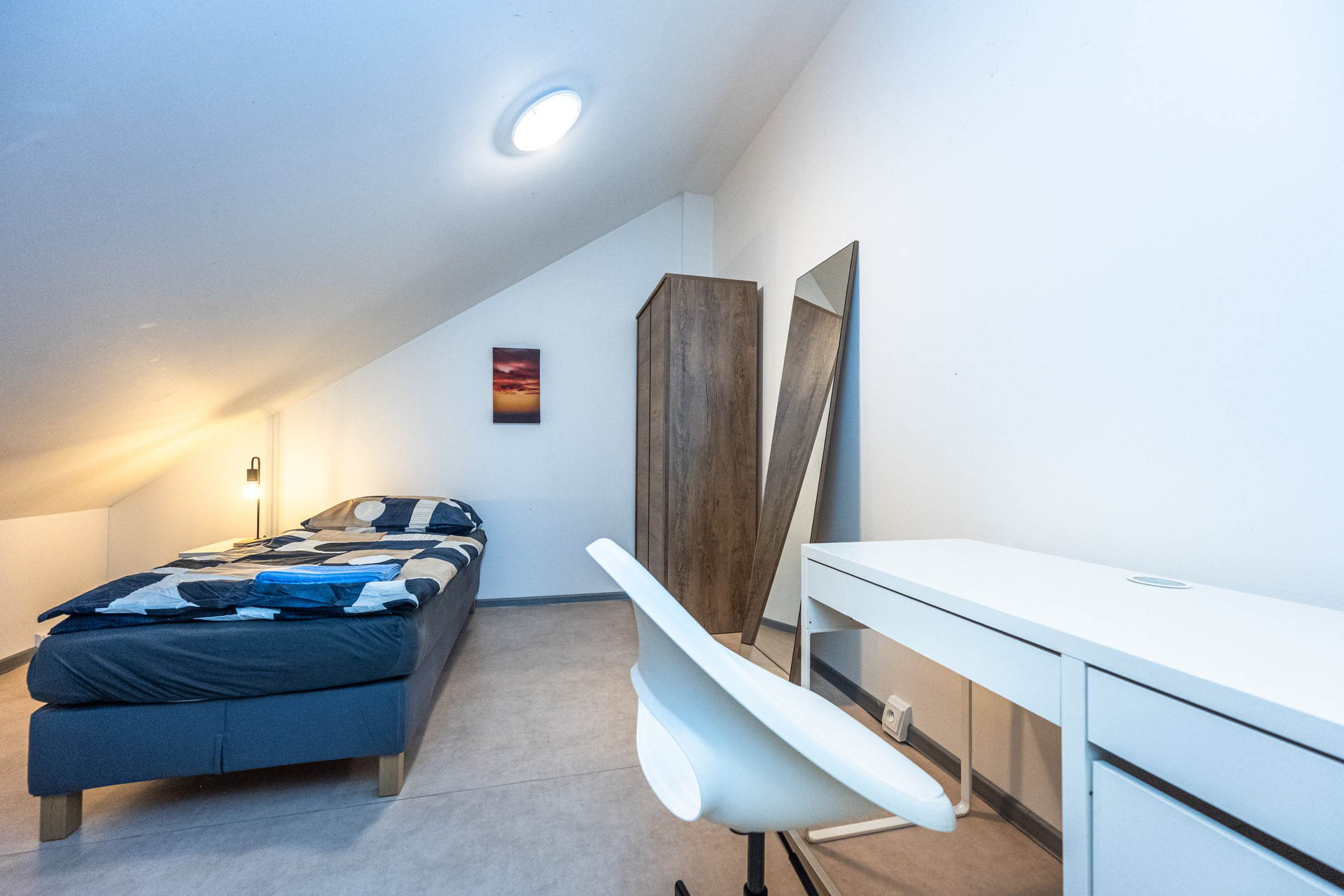 Attic bedroom with wardrobe and desk