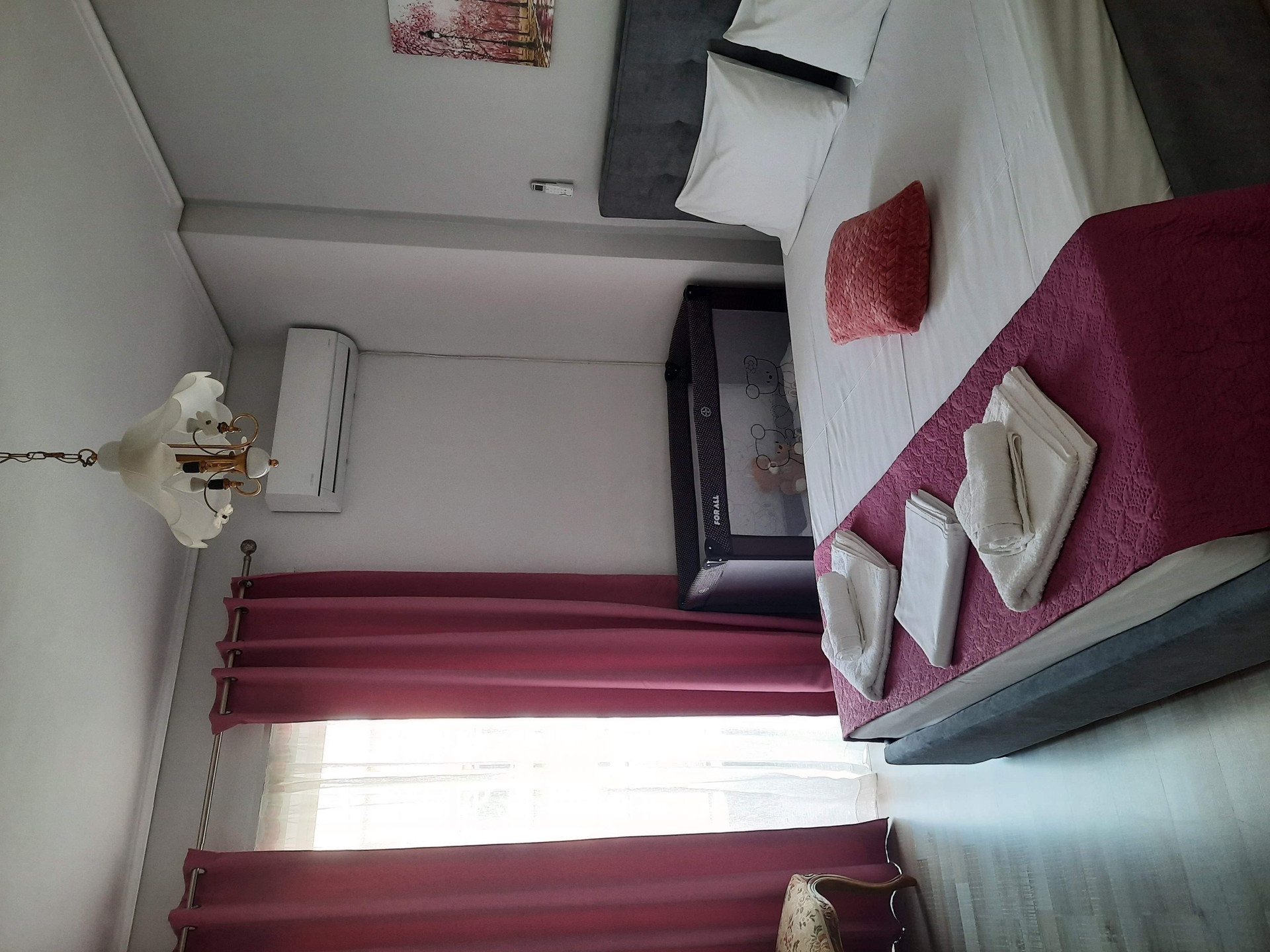 Bedroom with crib and towels