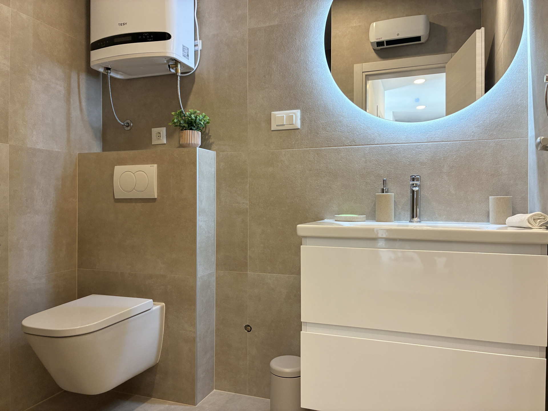 Modern bathroom with backlit mirror