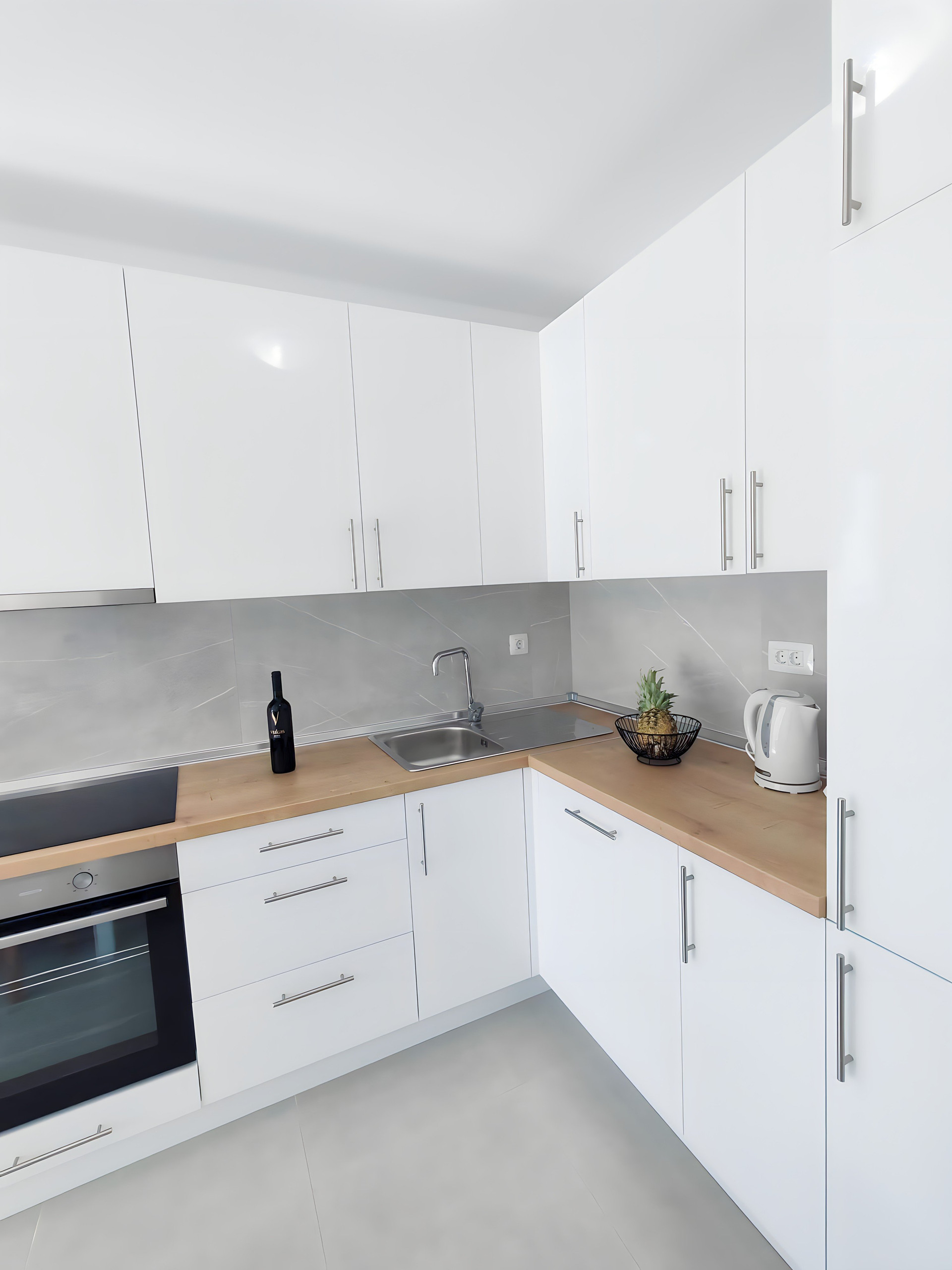 Modern white kitchen with wood counters