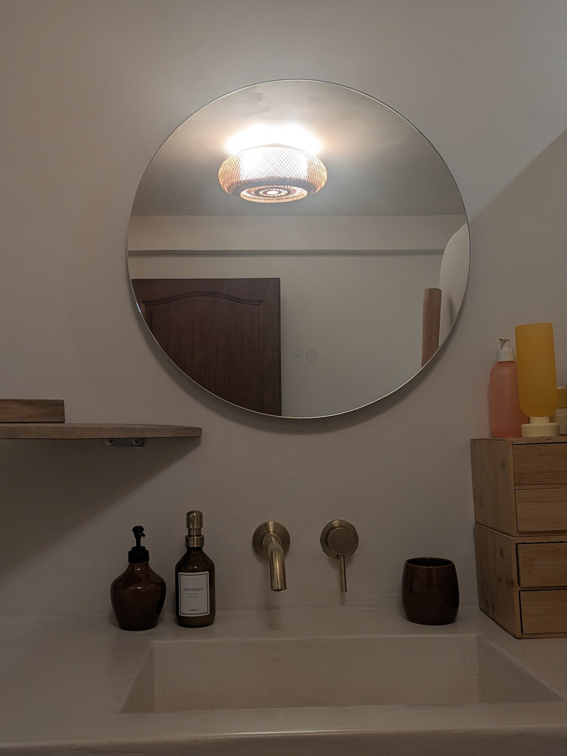 Bathroom sink with round mirror