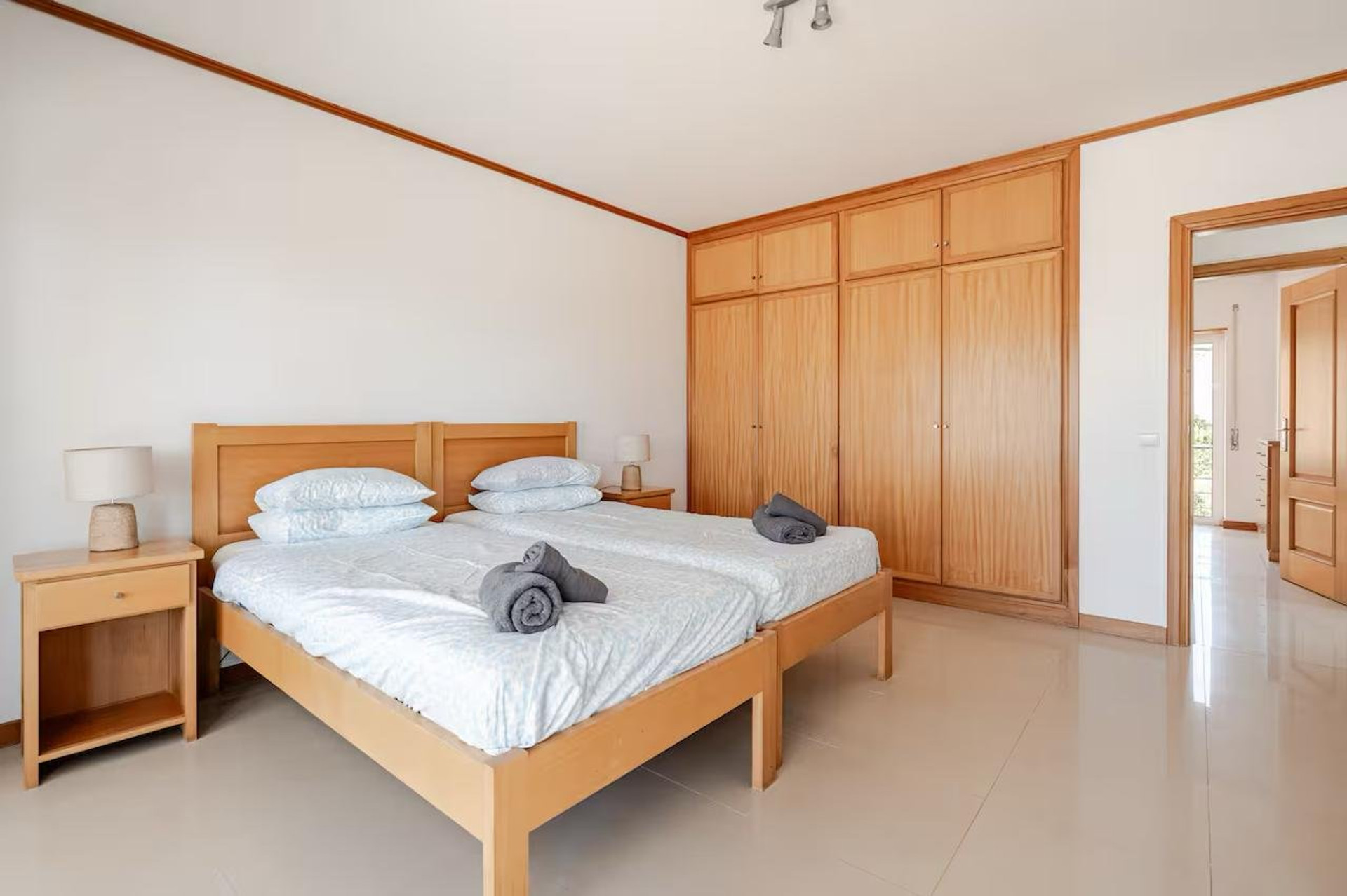 Twin bedroom with wooden wardrobe