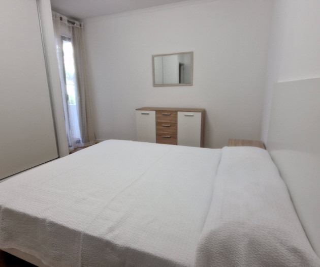 Bedroom with double bed and dresser