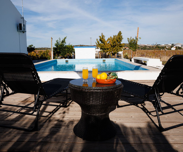 Sun loungers with drinks by pool