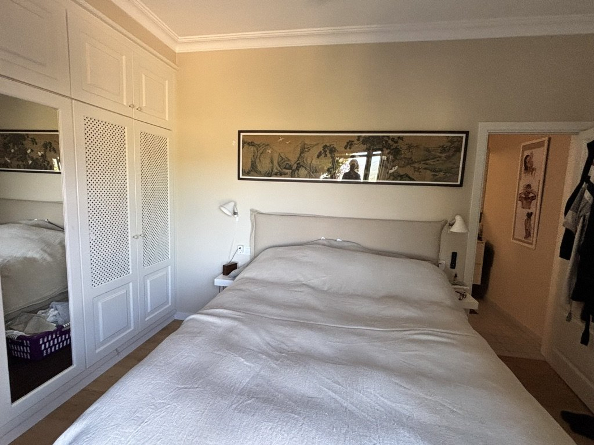 Bright master bedroom with built-in wardrobes