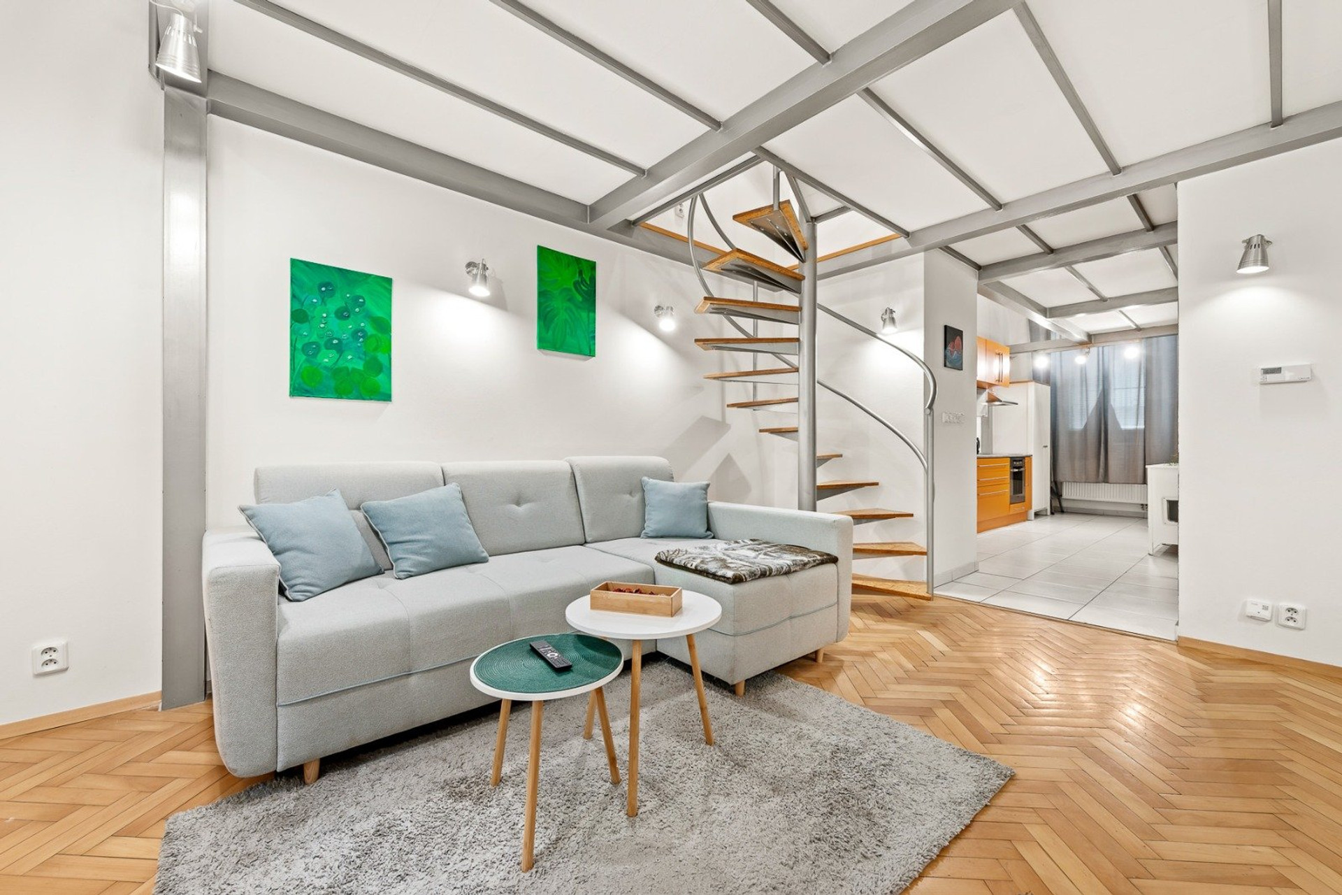 Living room with sofa, spiral staircase