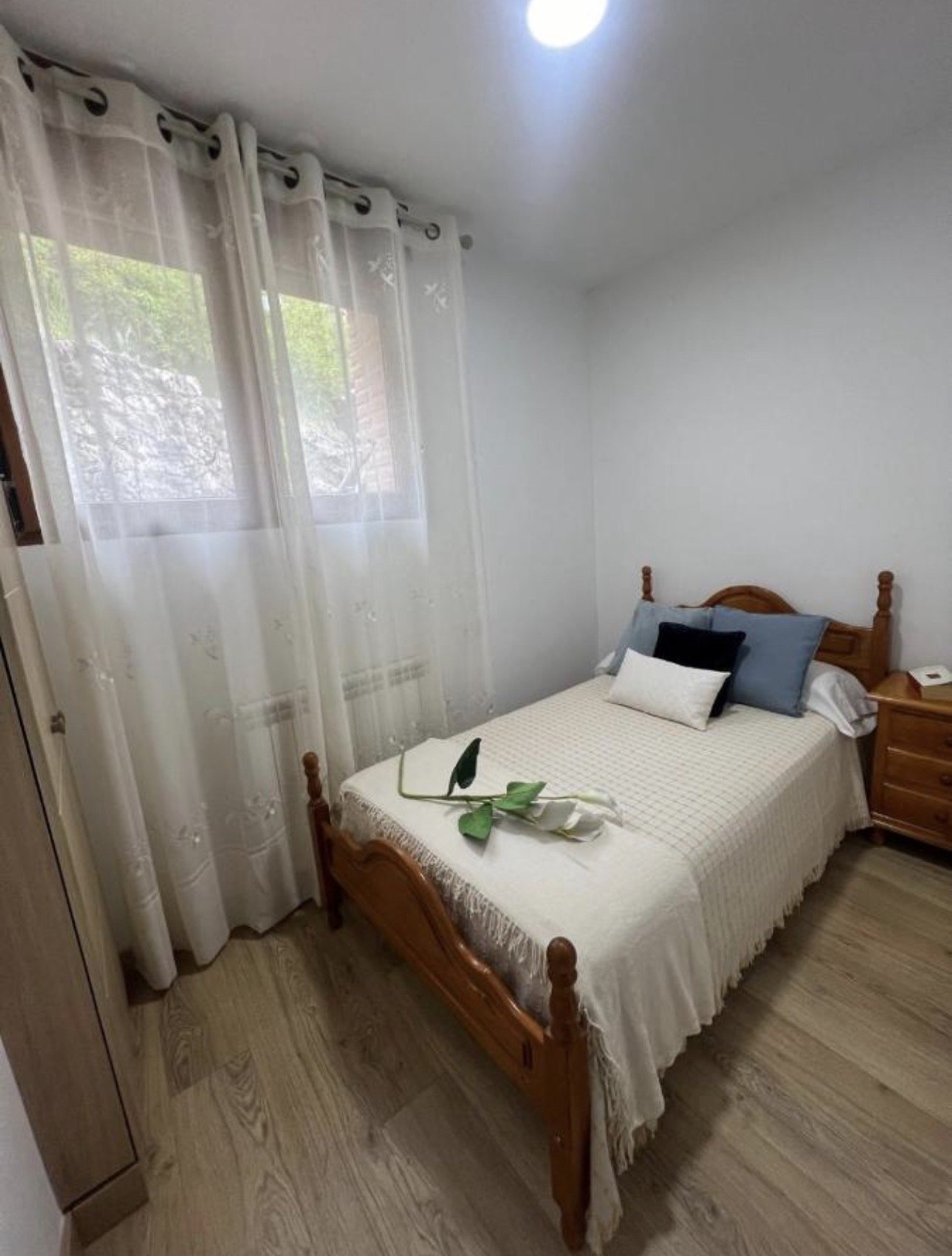 Cozy single bedroom with curtains