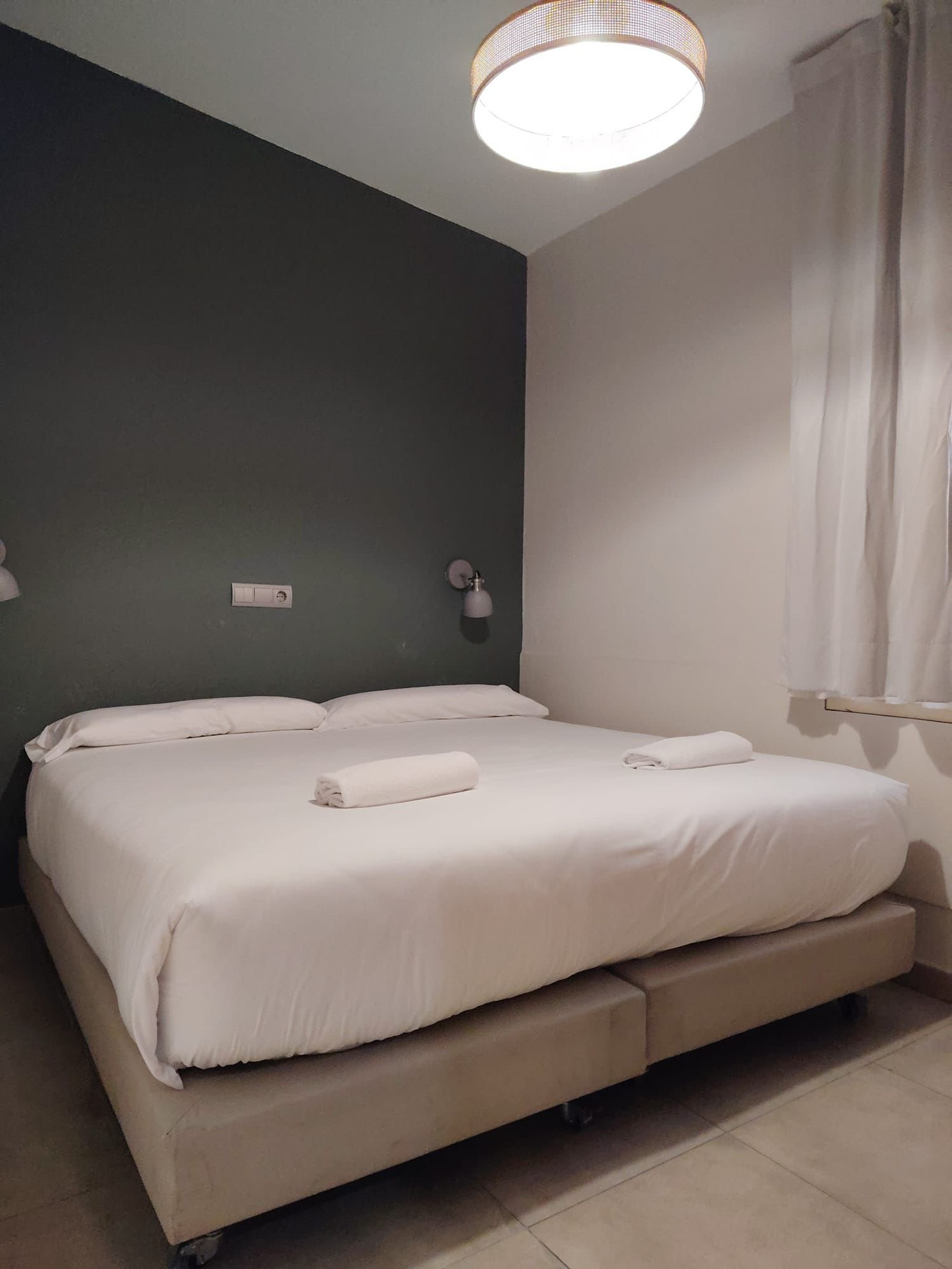 Double bedroom with green accent wall