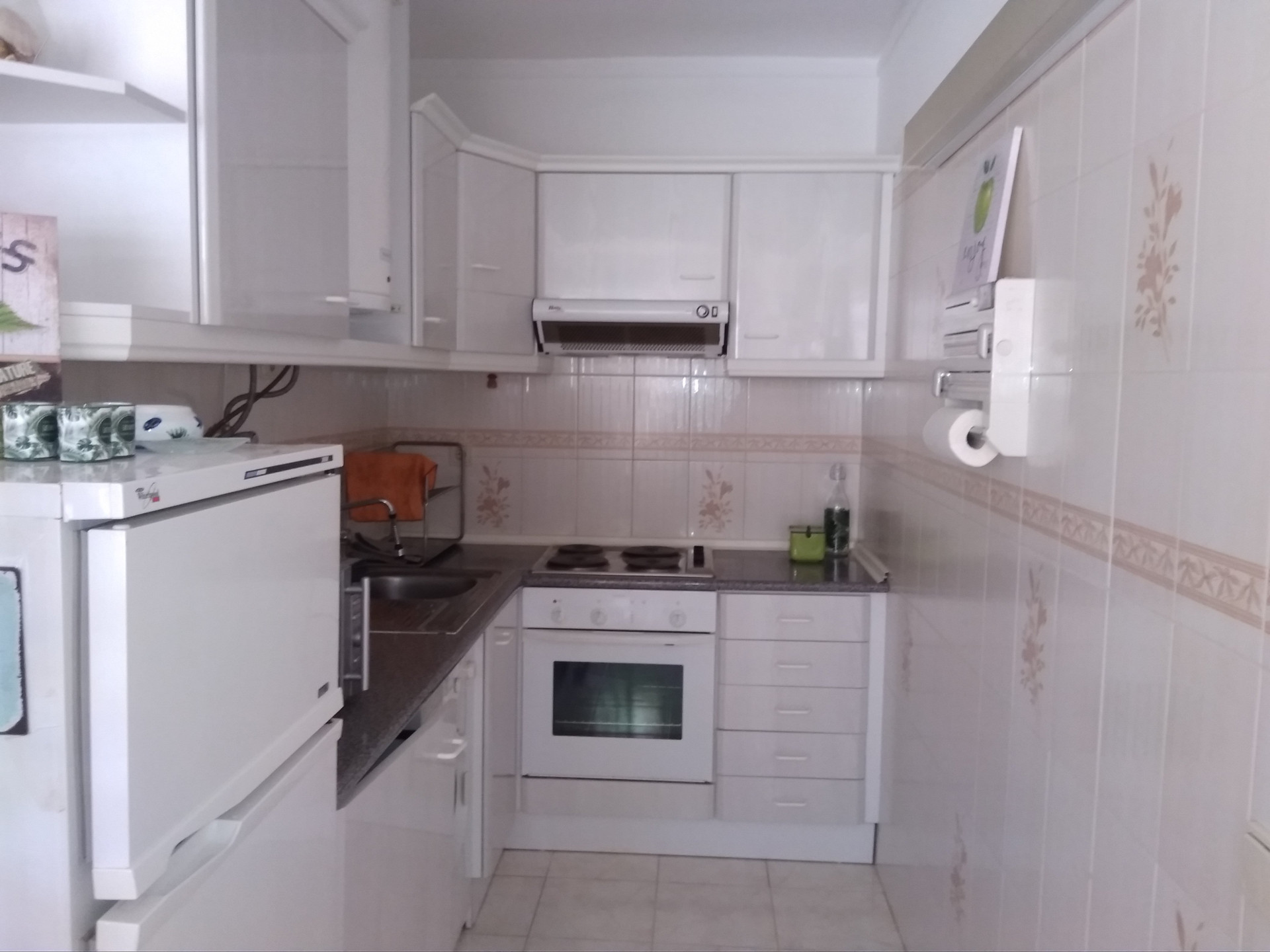 Compact white kitchen with oven