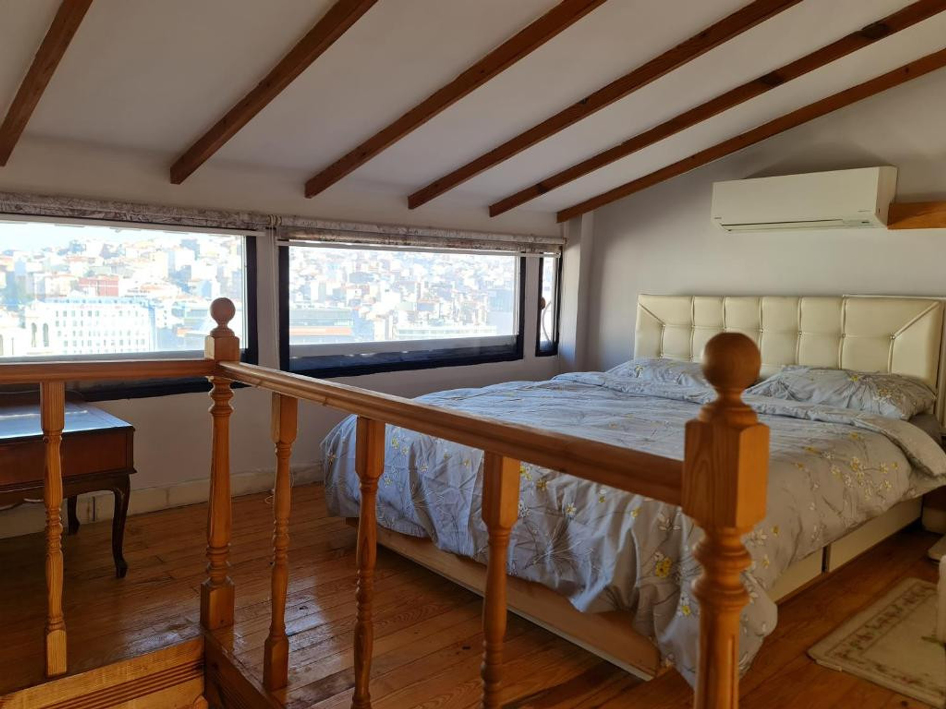 Bedroom with city view windows