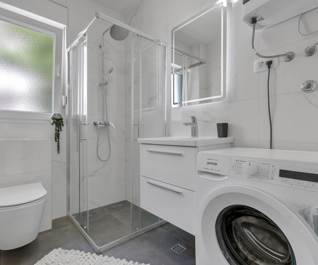 Bathroom with shower and washer