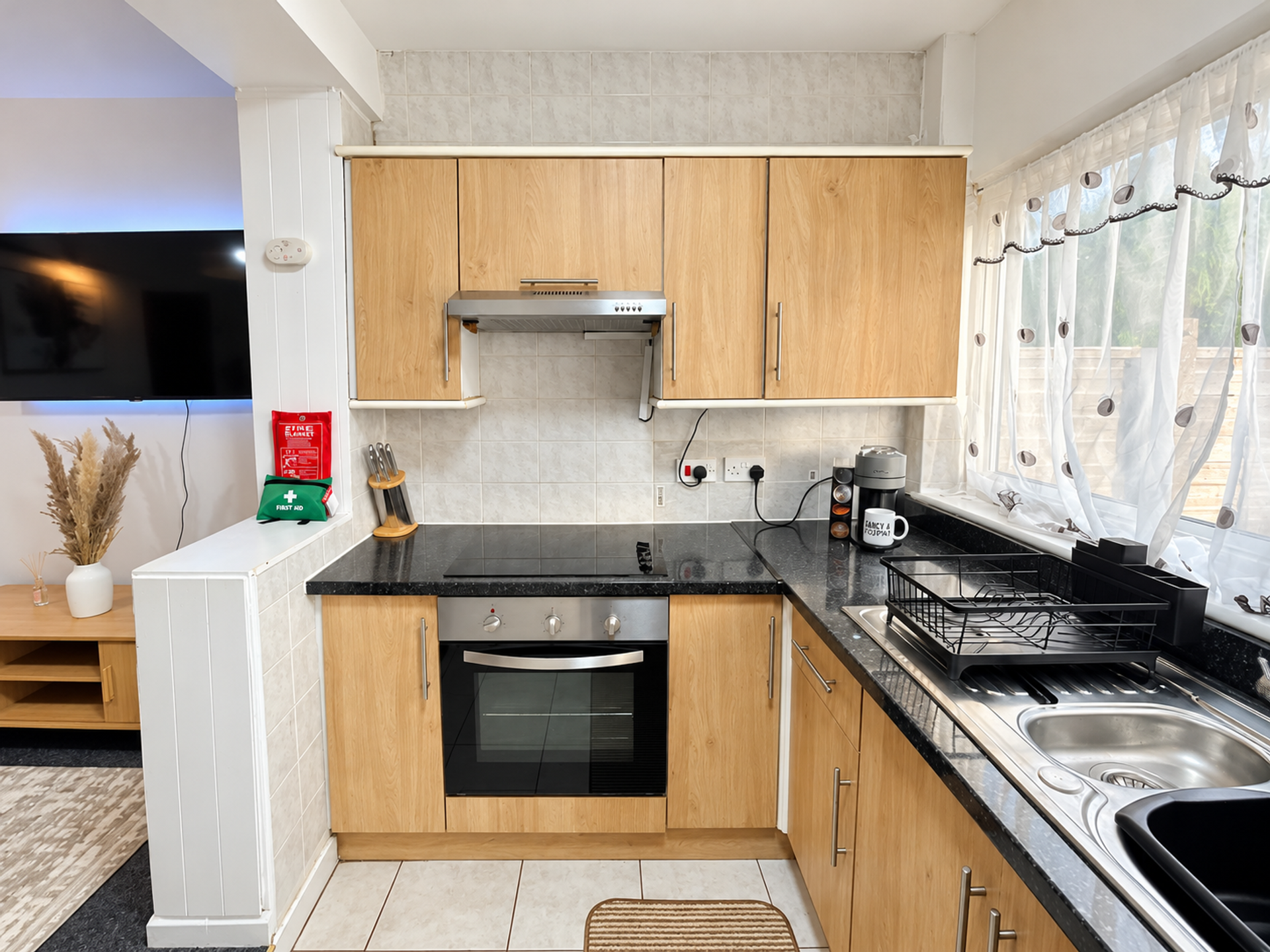 Kitchen with oven, hob, and sink