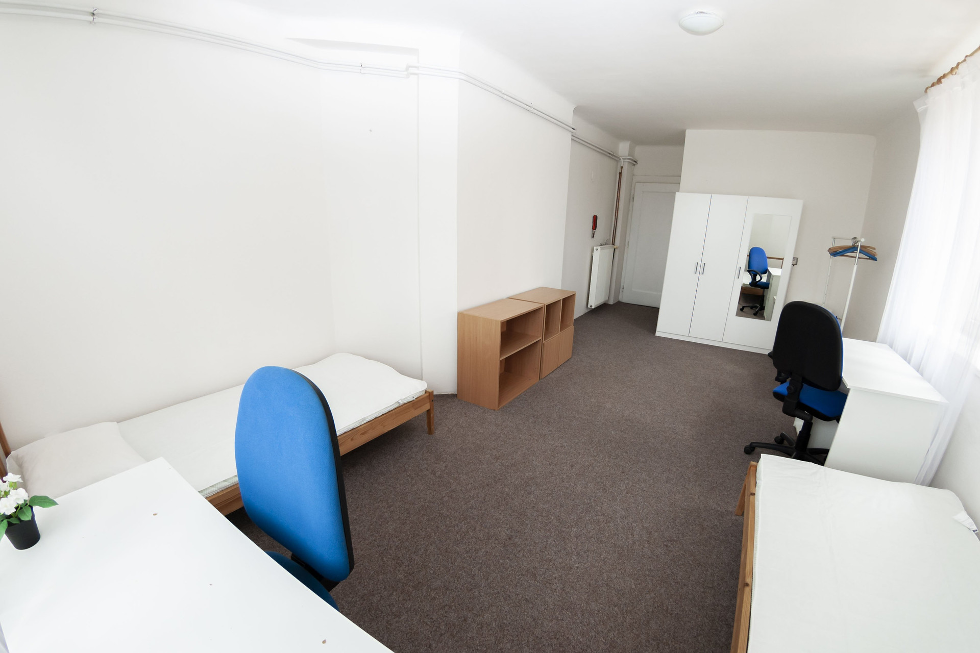 Spacious bedroom with wardrobe and desks