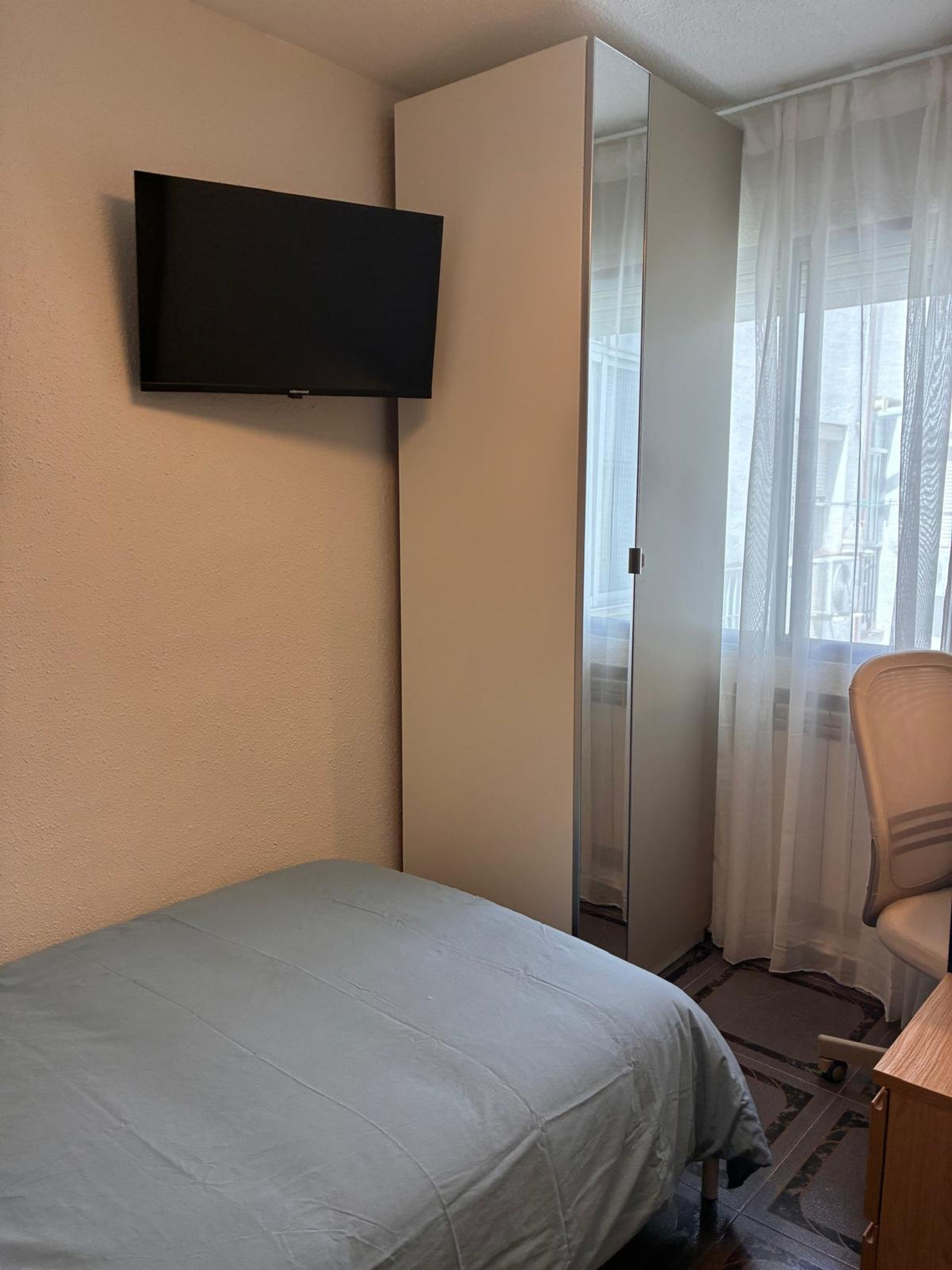 Bedroom with wardrobe and window