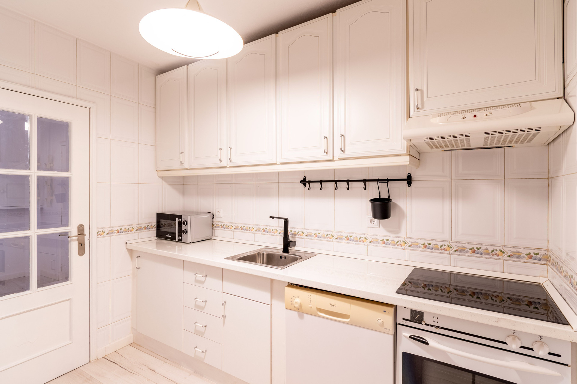 Full white kitchen with appliances