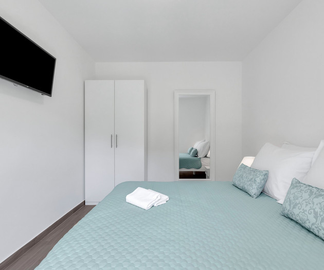 Bedroom with TV and wardrobe