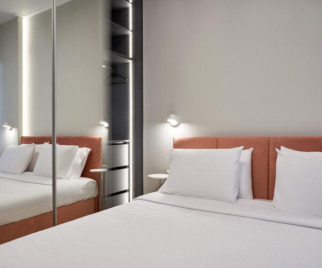 The bedroom with a king size bed and a mirror closet