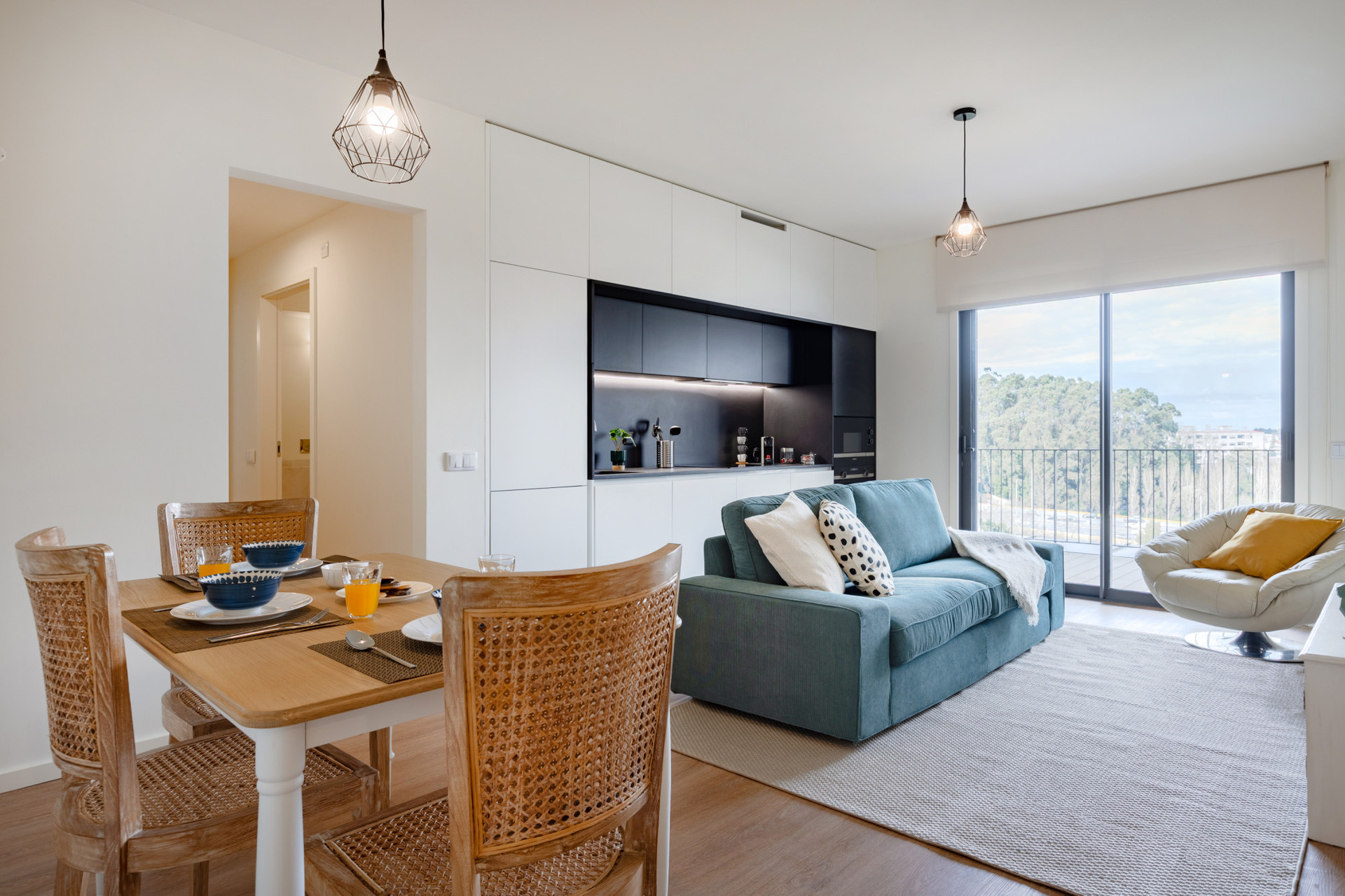 Living Area with a TV, Sofa, Kitchenette and Dining Table