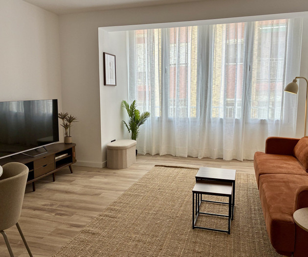 Bright living room with orange sofa