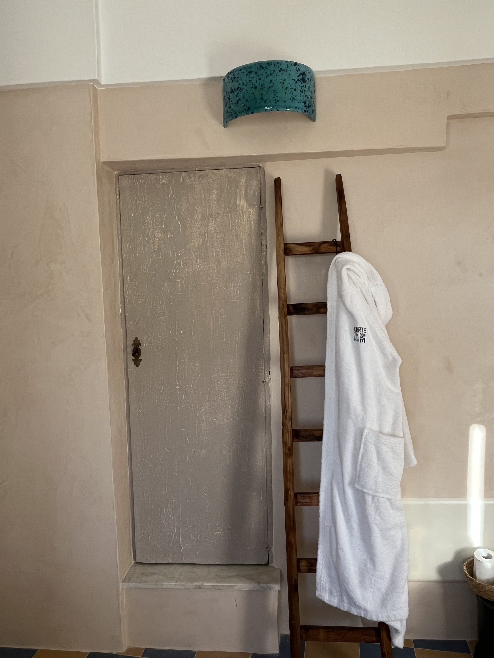 Bathroom with robe and ladder