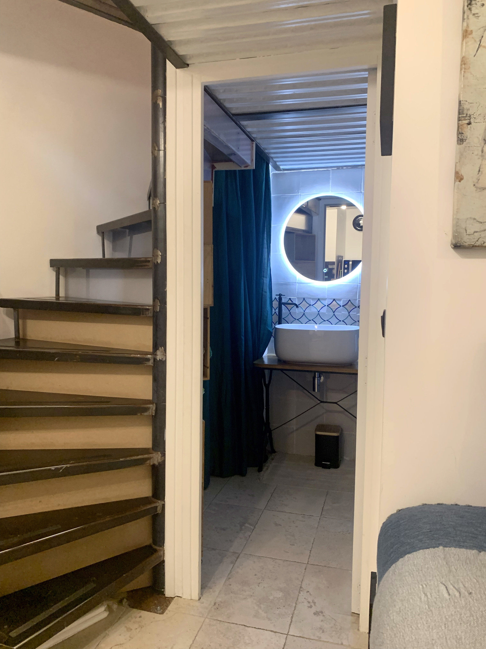 Down a semi-spiral staircase, you’ll reach the fully equipped kitchen.