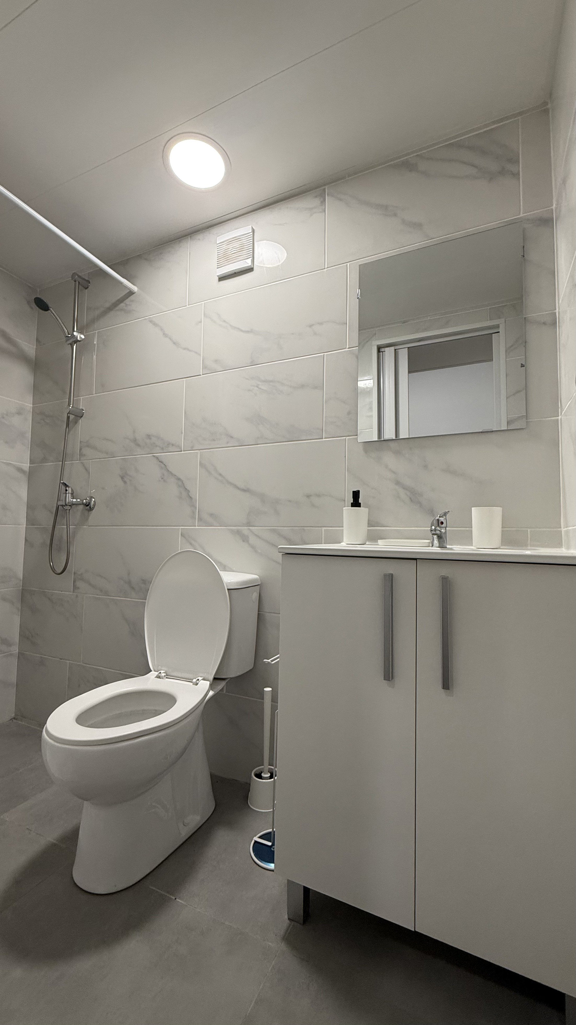 Bright bathroom with shower and vanity