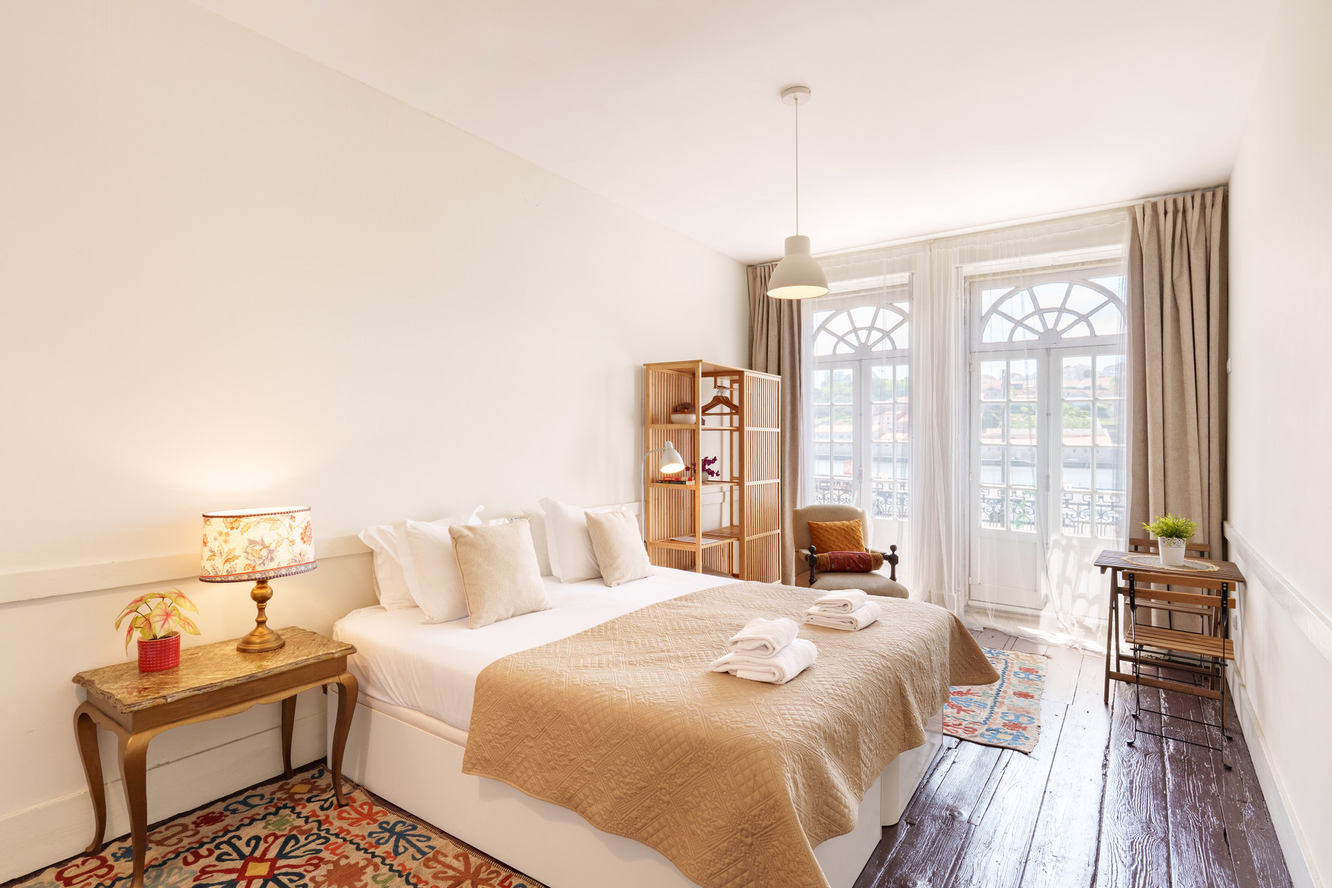 Spacious bedroom with arched balcony windows