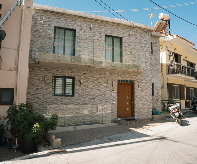 Stone-clad building facade, front door