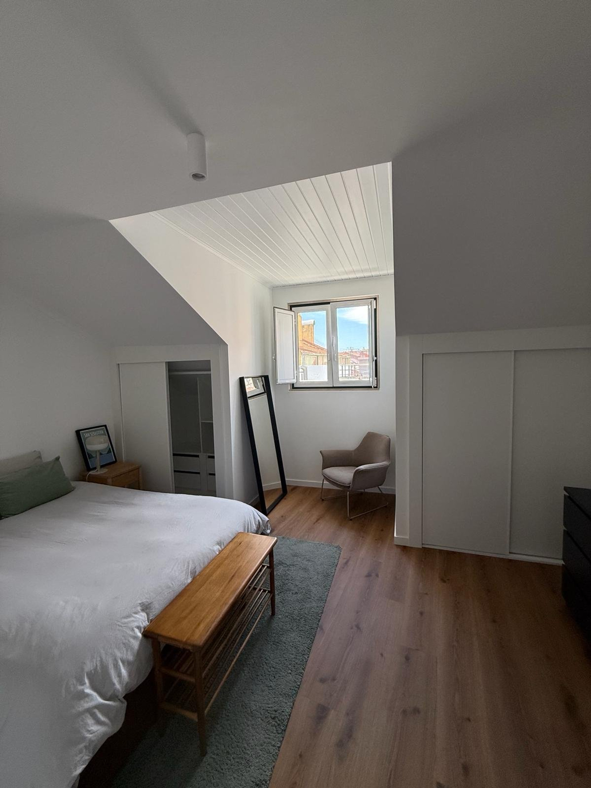 Bright bedroom with sloped ceiling