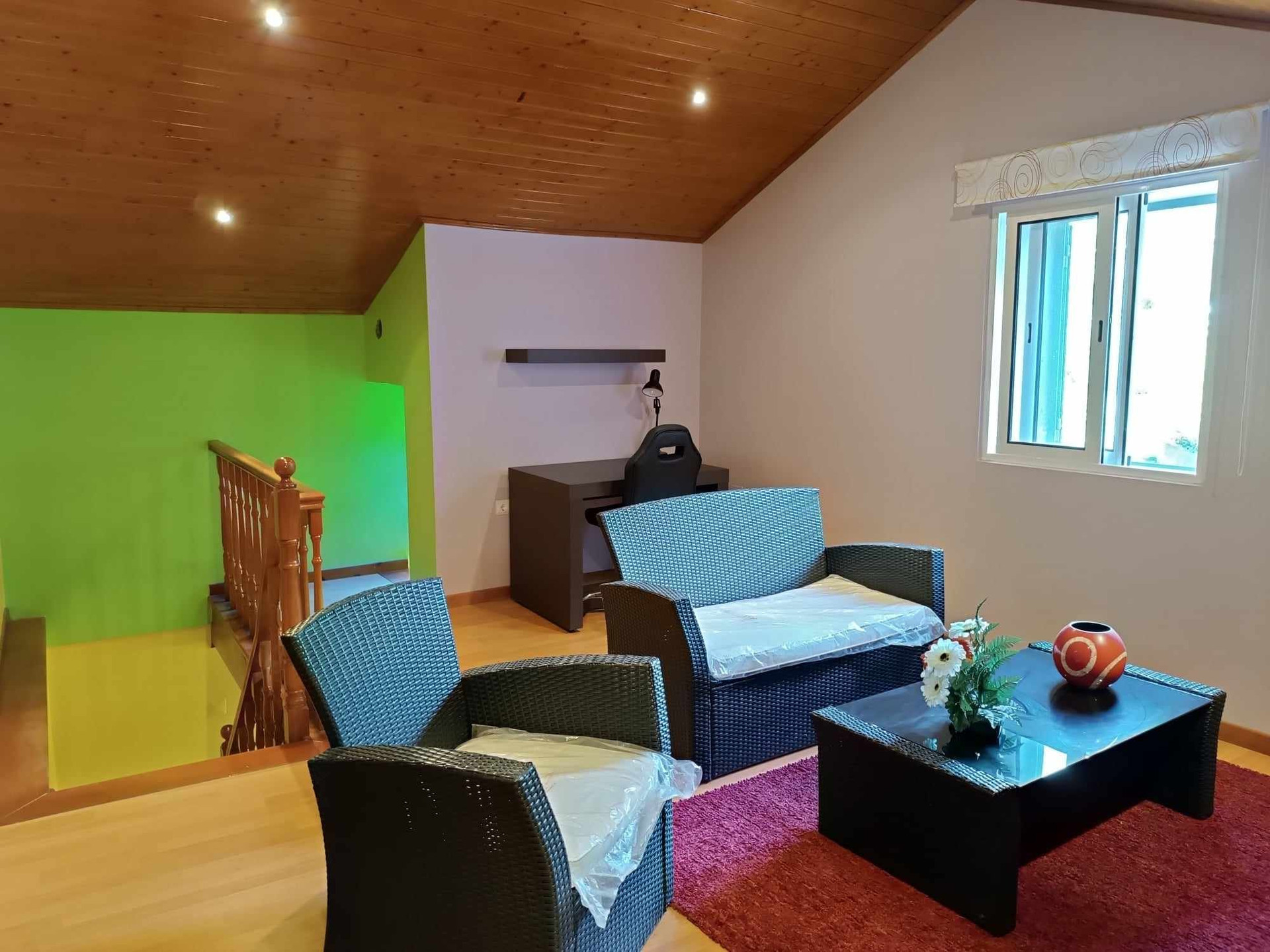 Upstairs lounge with desk and wicker seating