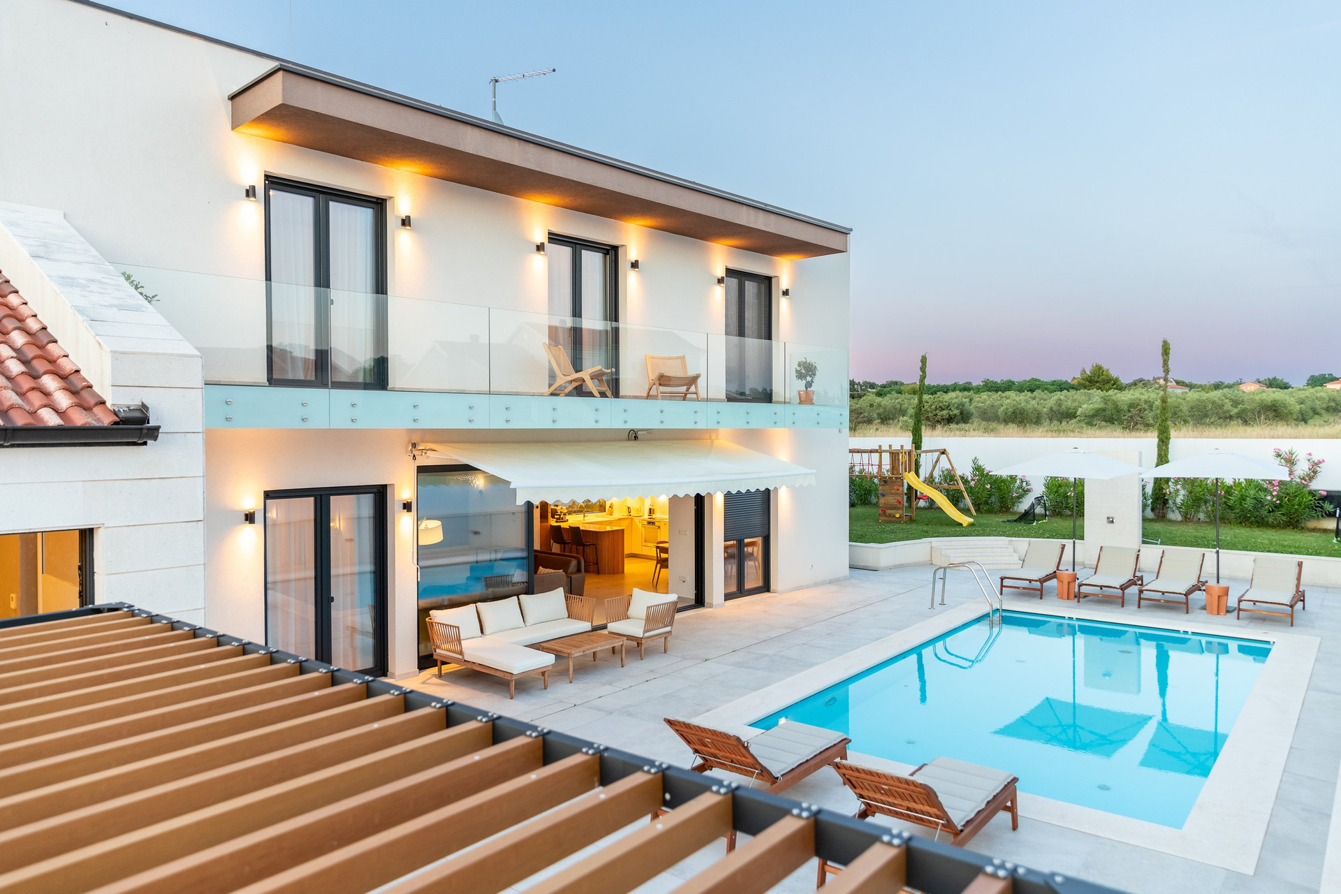 Villa pool aerial dusk view