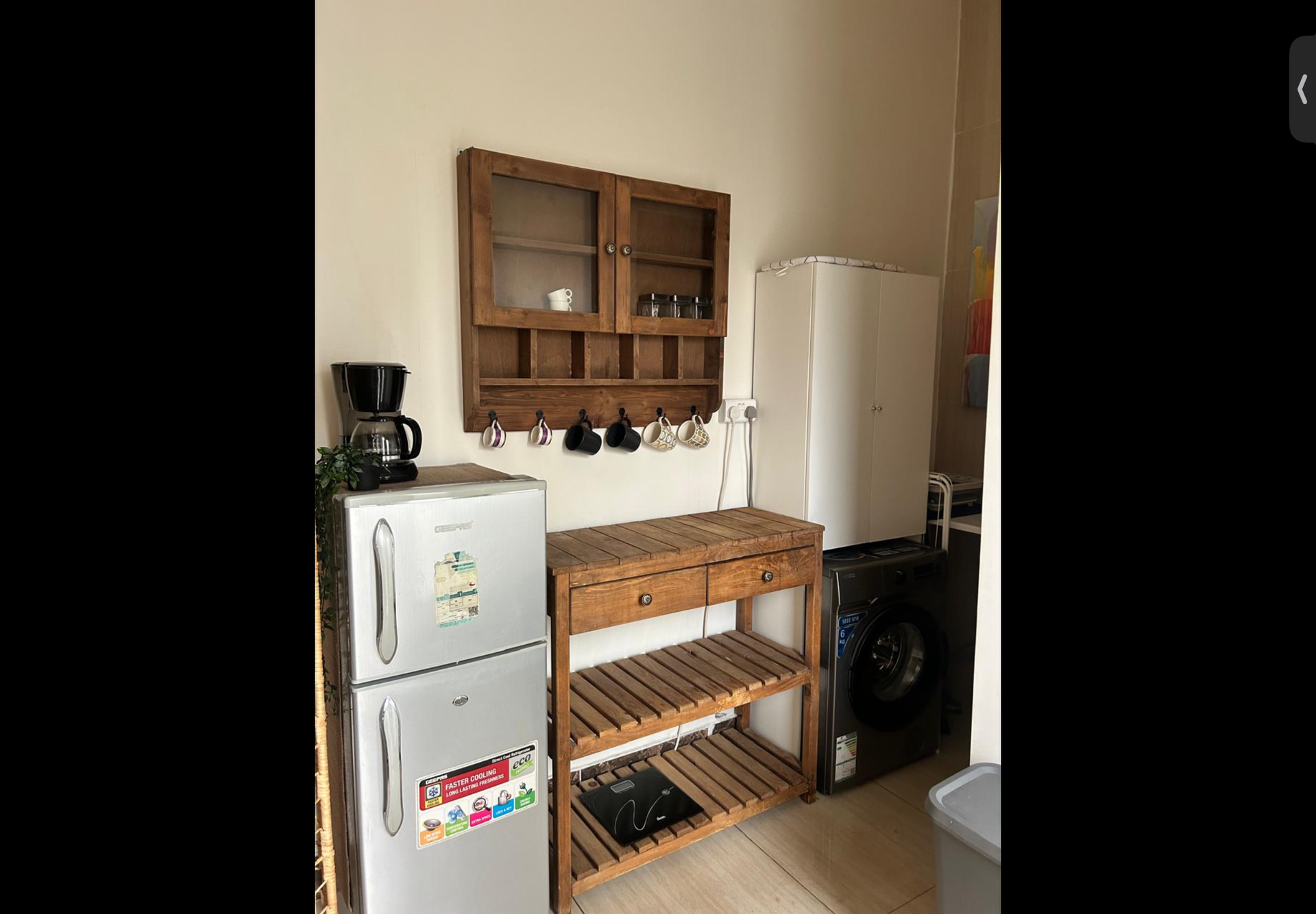 Kitchenette with fridge and washer