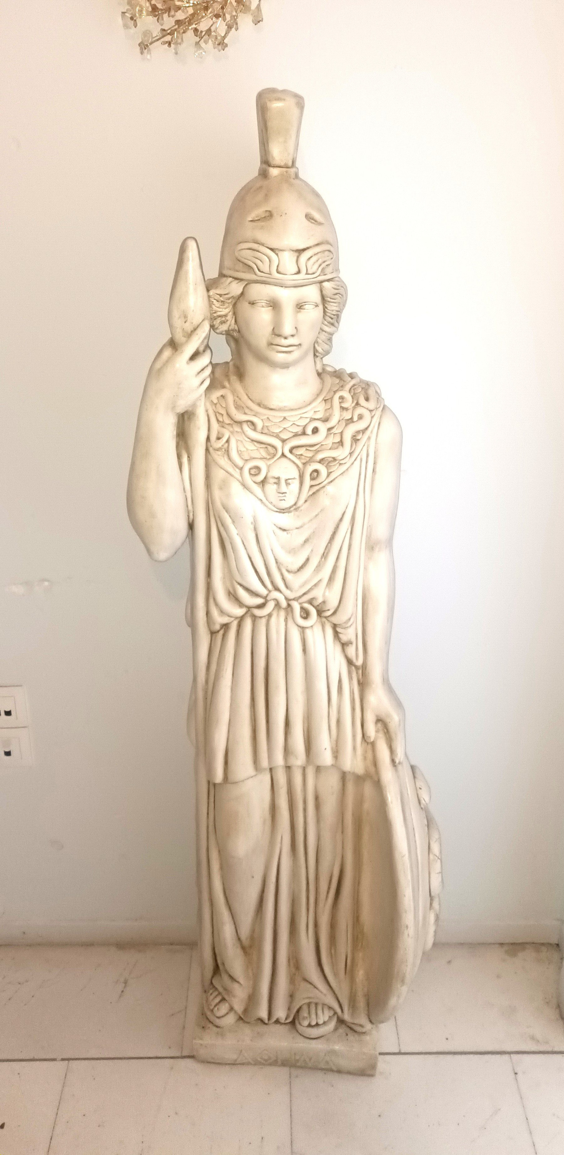The statue of Athena - the war godess with shield and helmet .