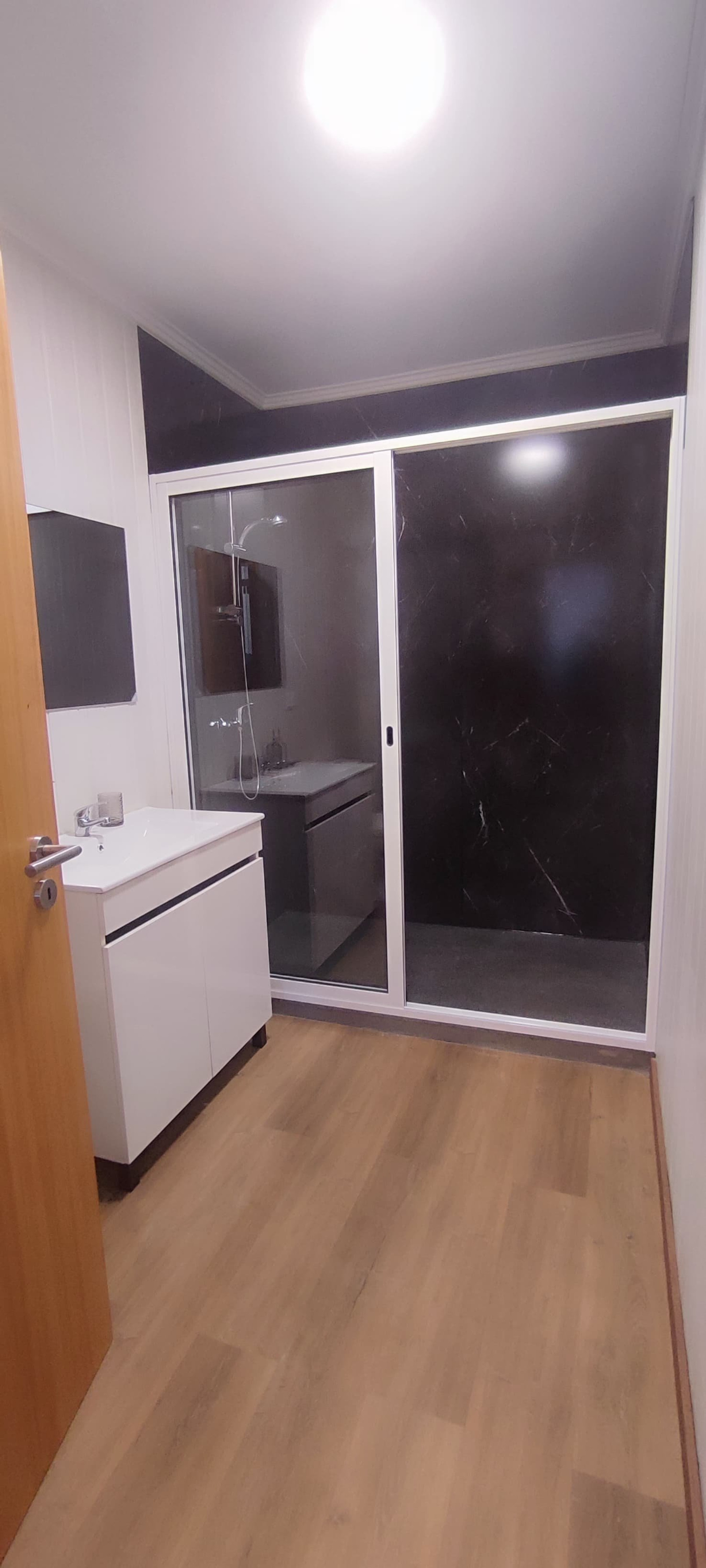 Bathroom with dark marble shower