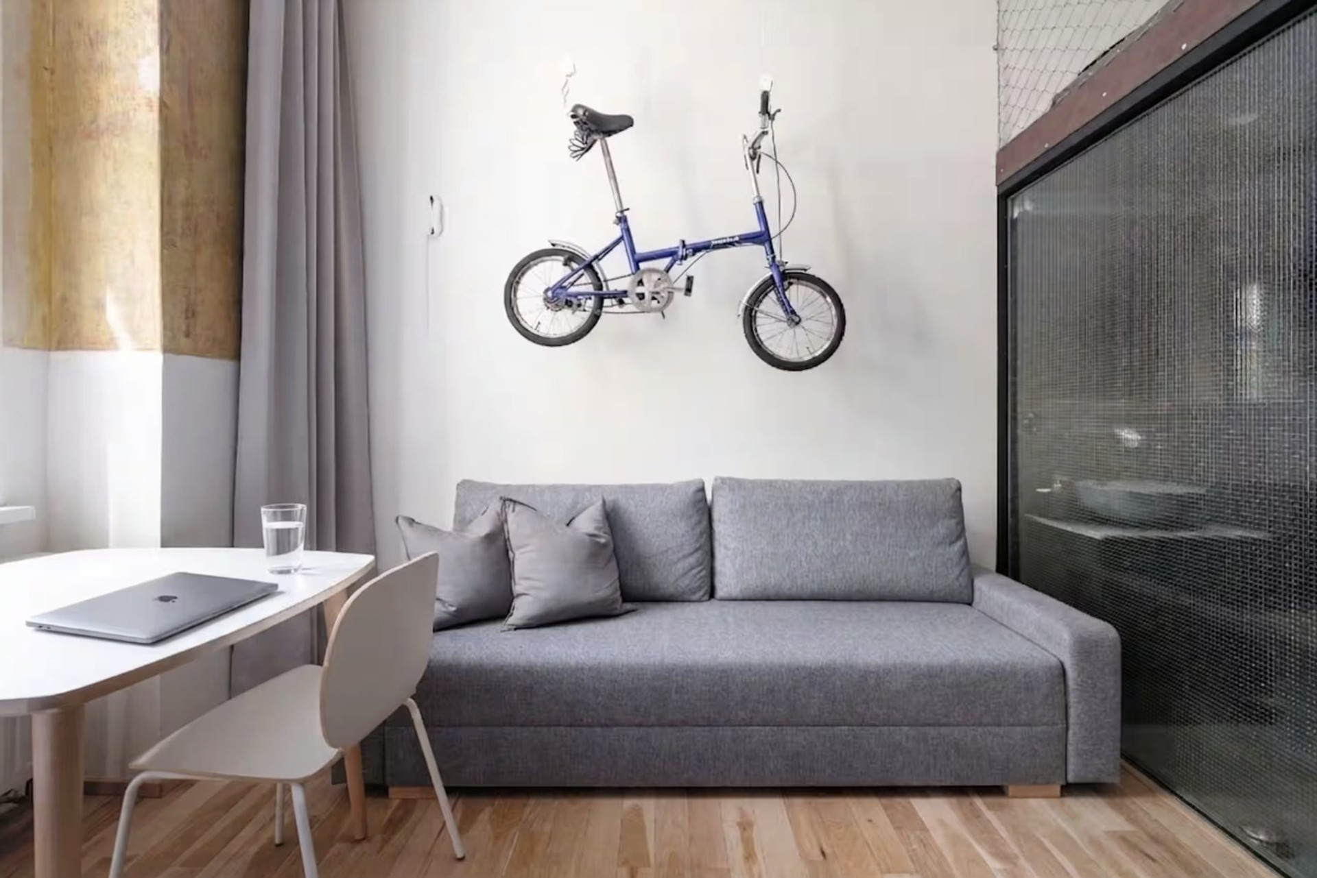 Sofa with wall-mounted bike and desk