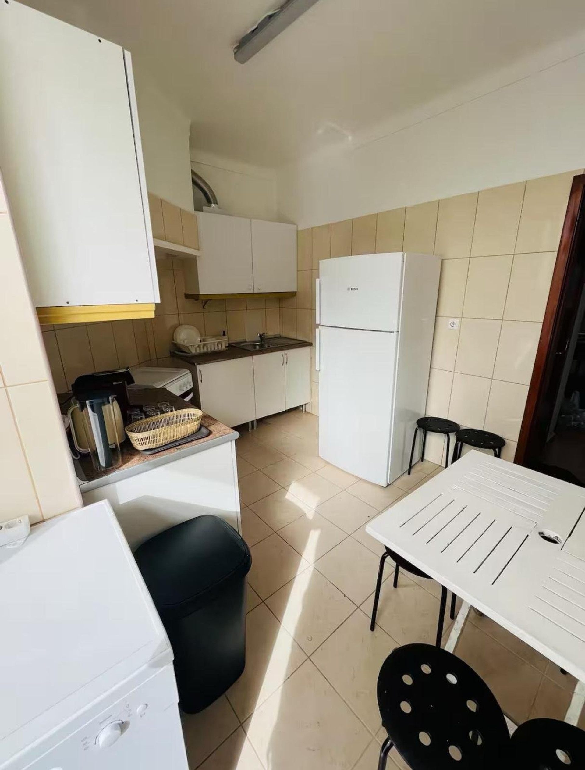Kitchen with fridge and dining table