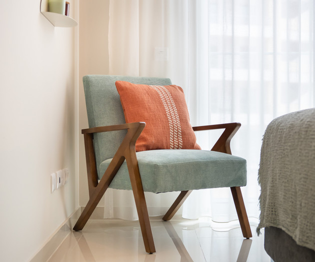 Green armchair with pillow