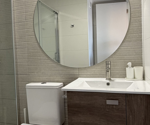 Bathroom vanity with round mirror