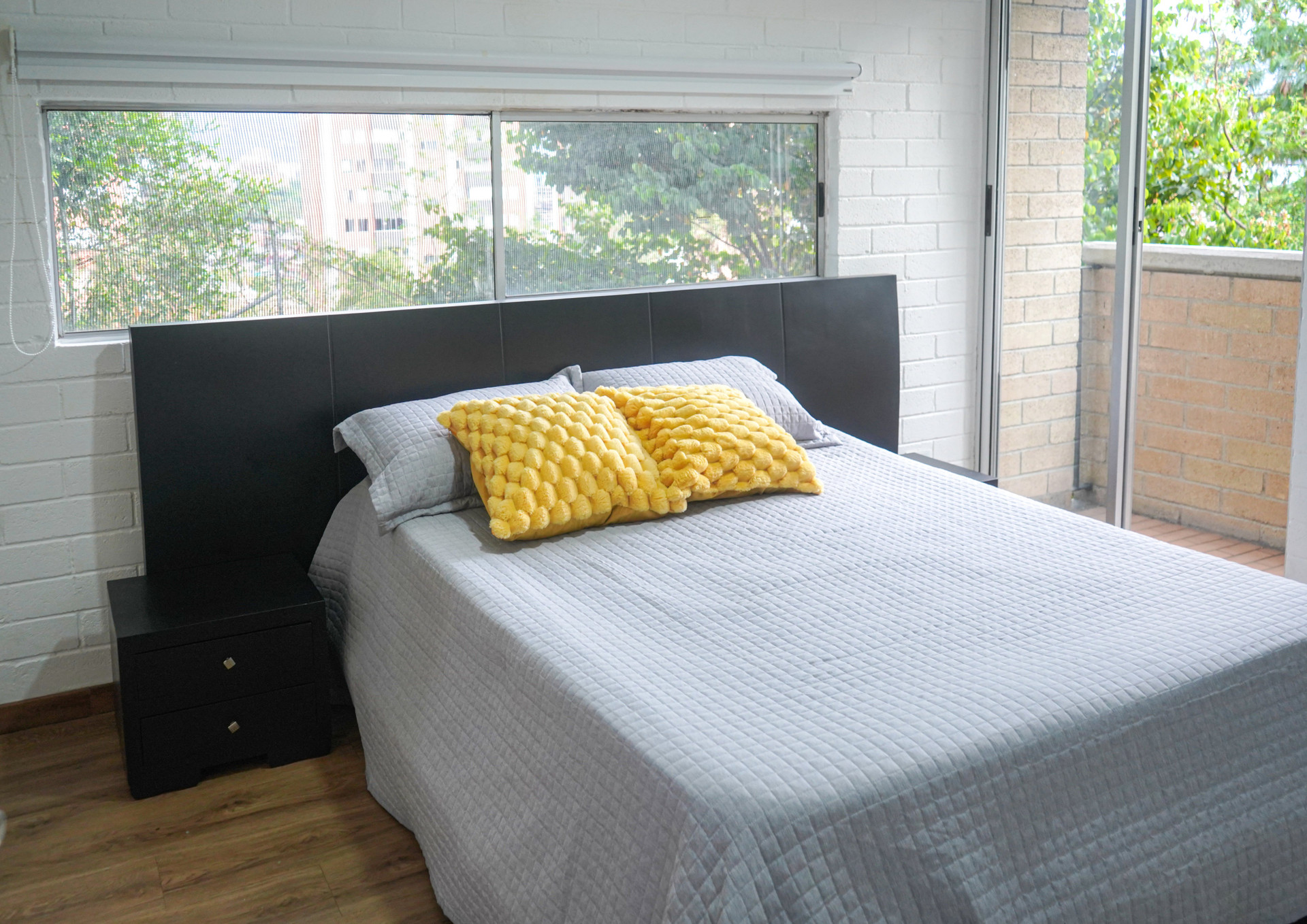 Master bedroom dark headboard window