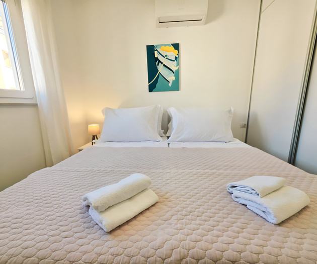 Bedroom with towels and art