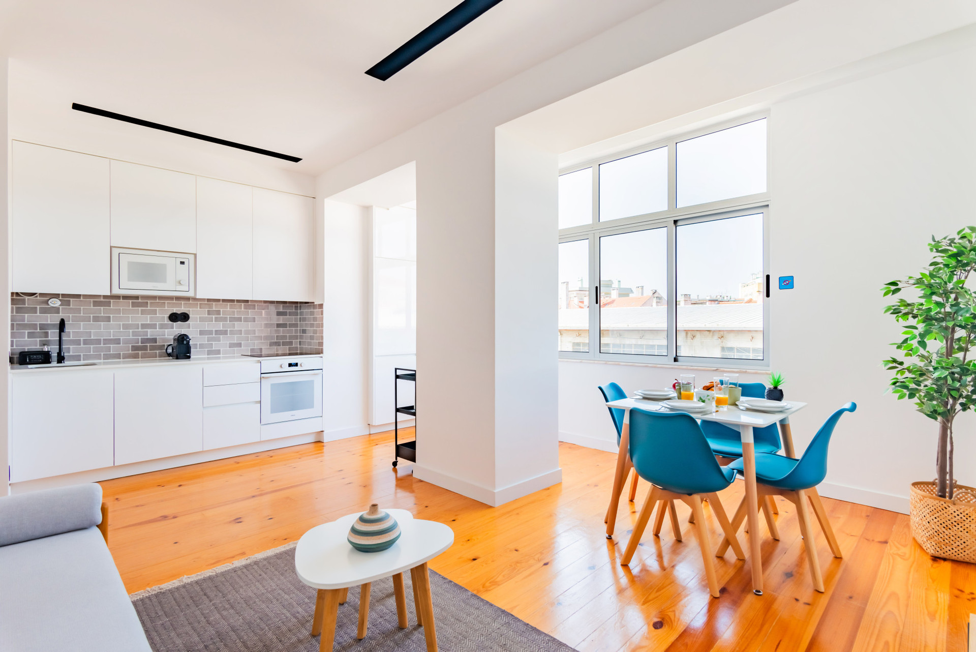 Living Room with TV, Dining Table and Air Conditioner. Fully Equipped Open Space Kitchen.