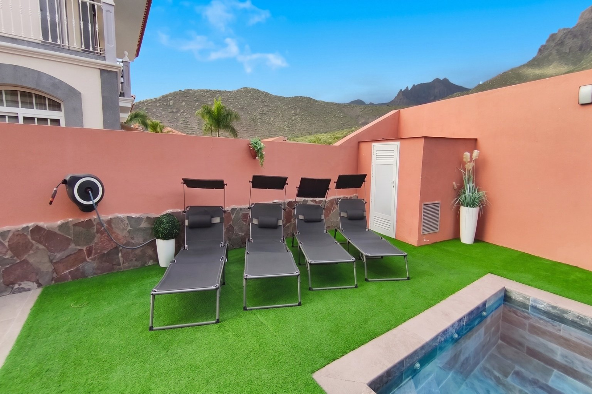 Sun loungers beside plunge pool