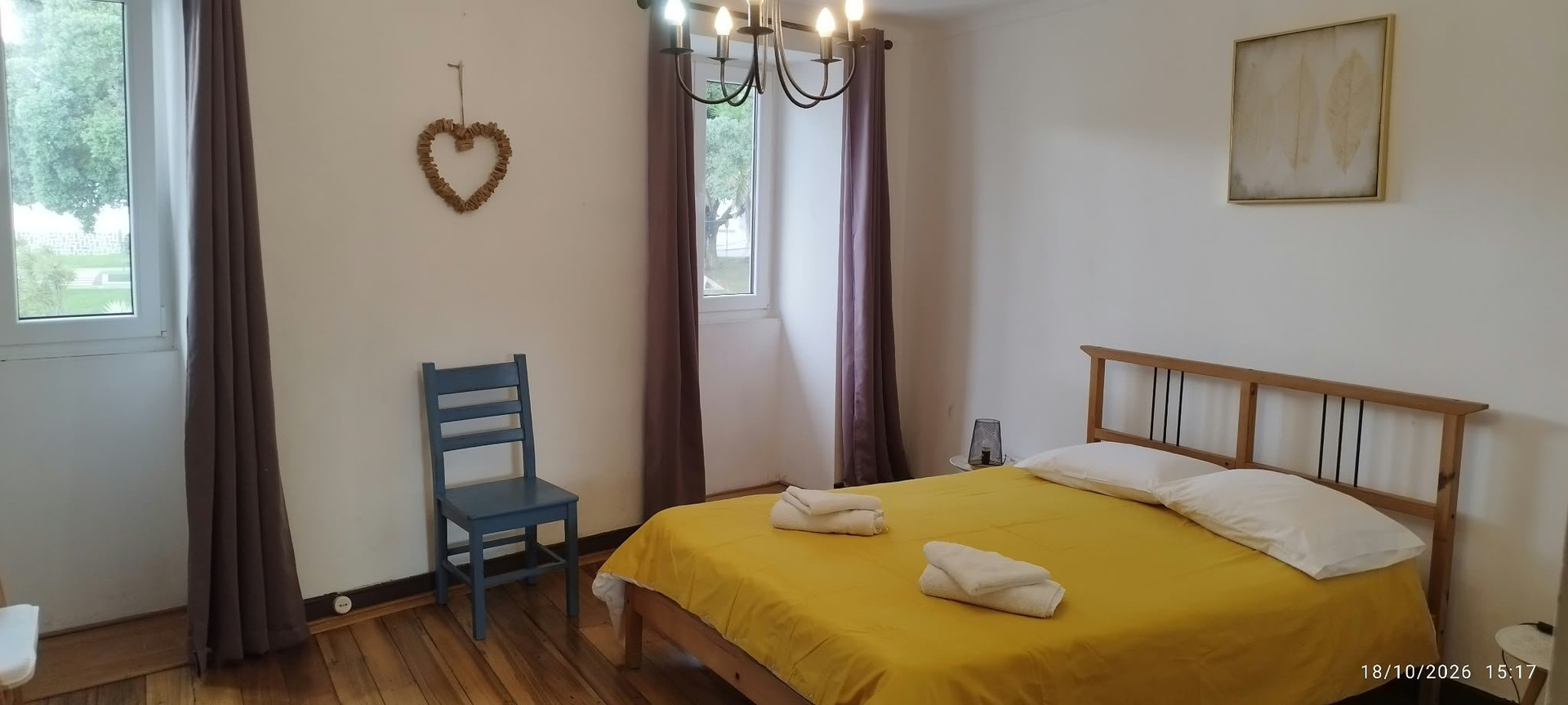 Bright bedroom with yellow bedspread