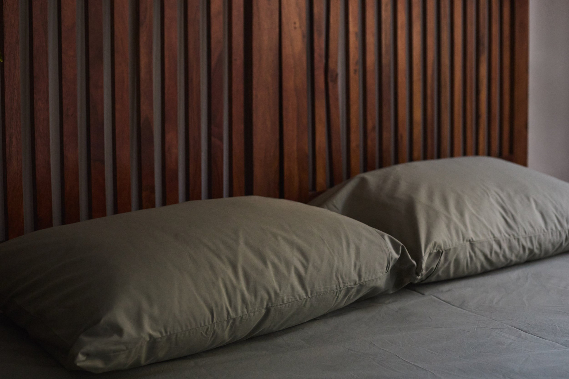 Close-up bed pillows wood headboard