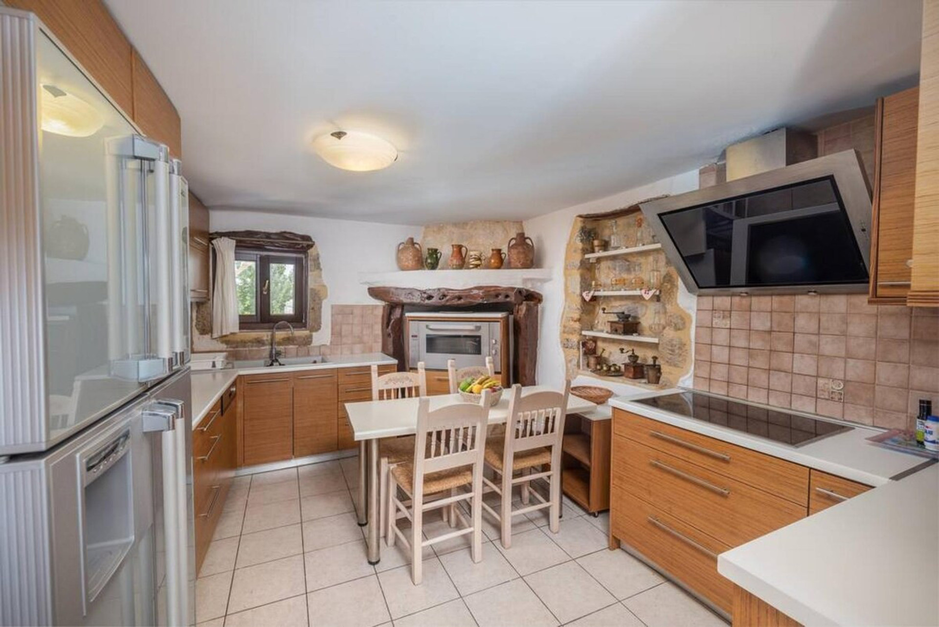 View of the kitchen, fully equipped, large fridge, oven, dining table.