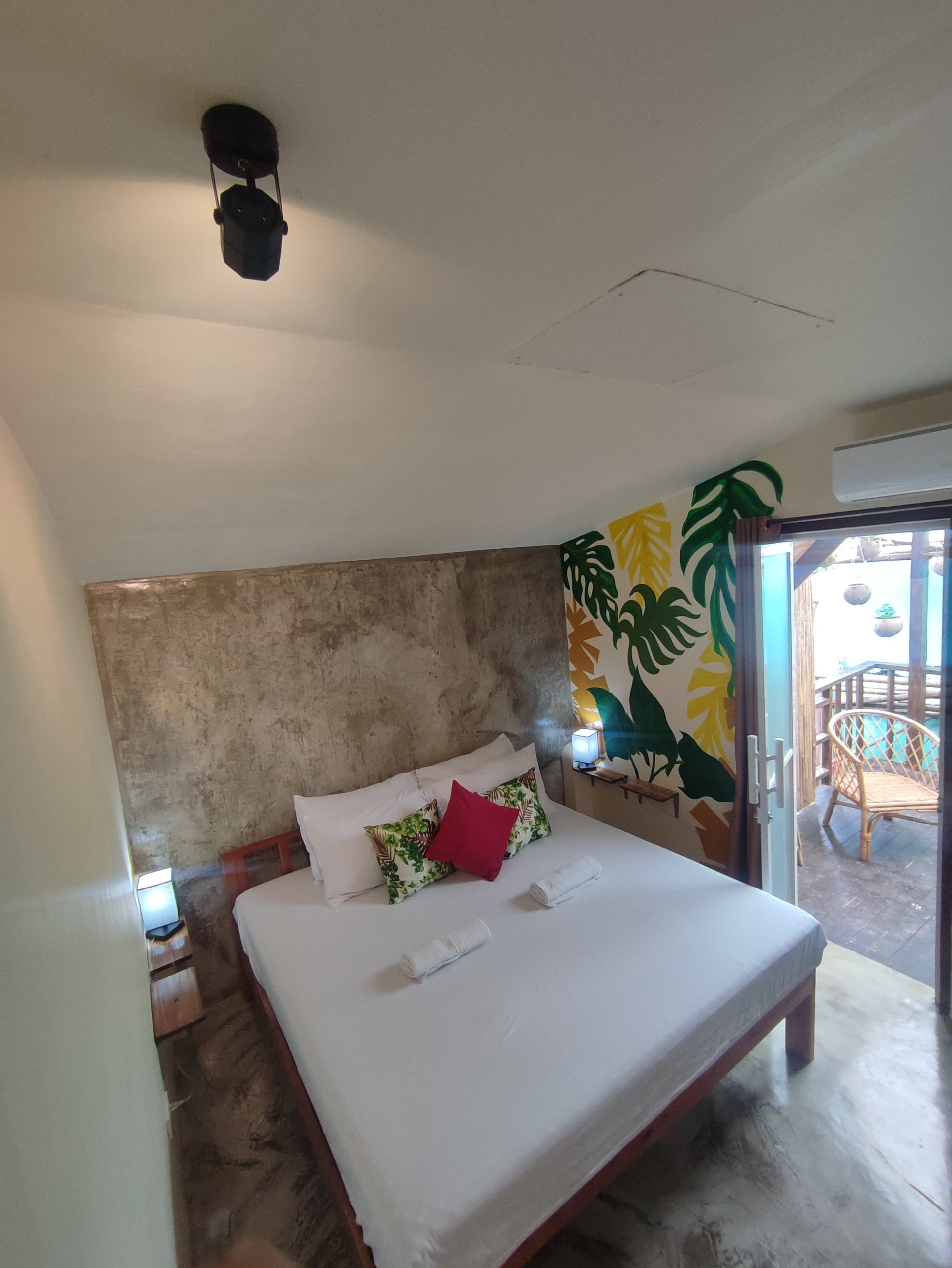 Bedroom with tropical mural and balcony