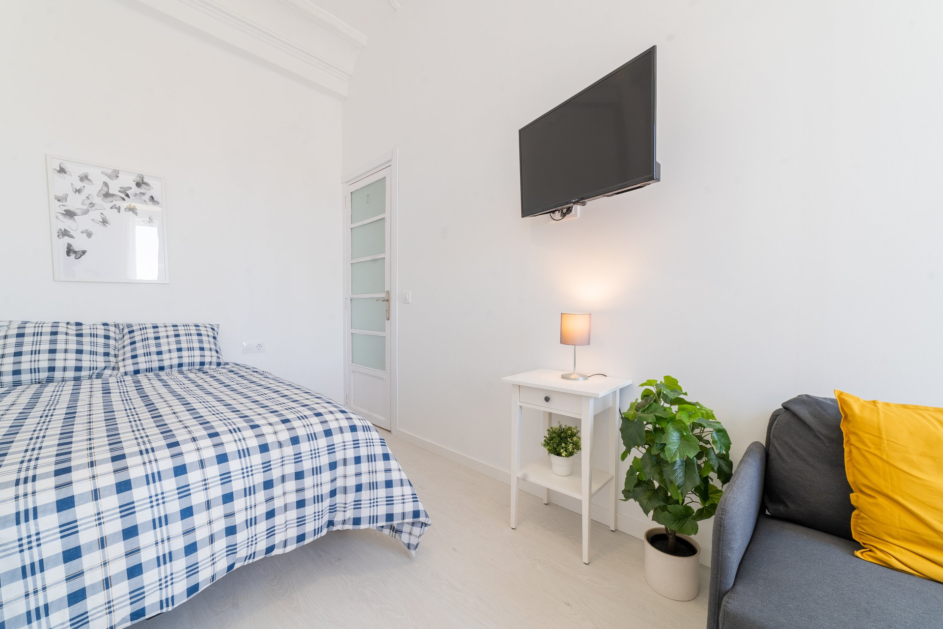 Bright bedroom with TV and sofa