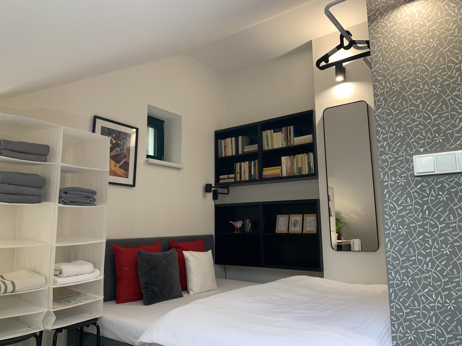 Bed with bookshelf and mirror