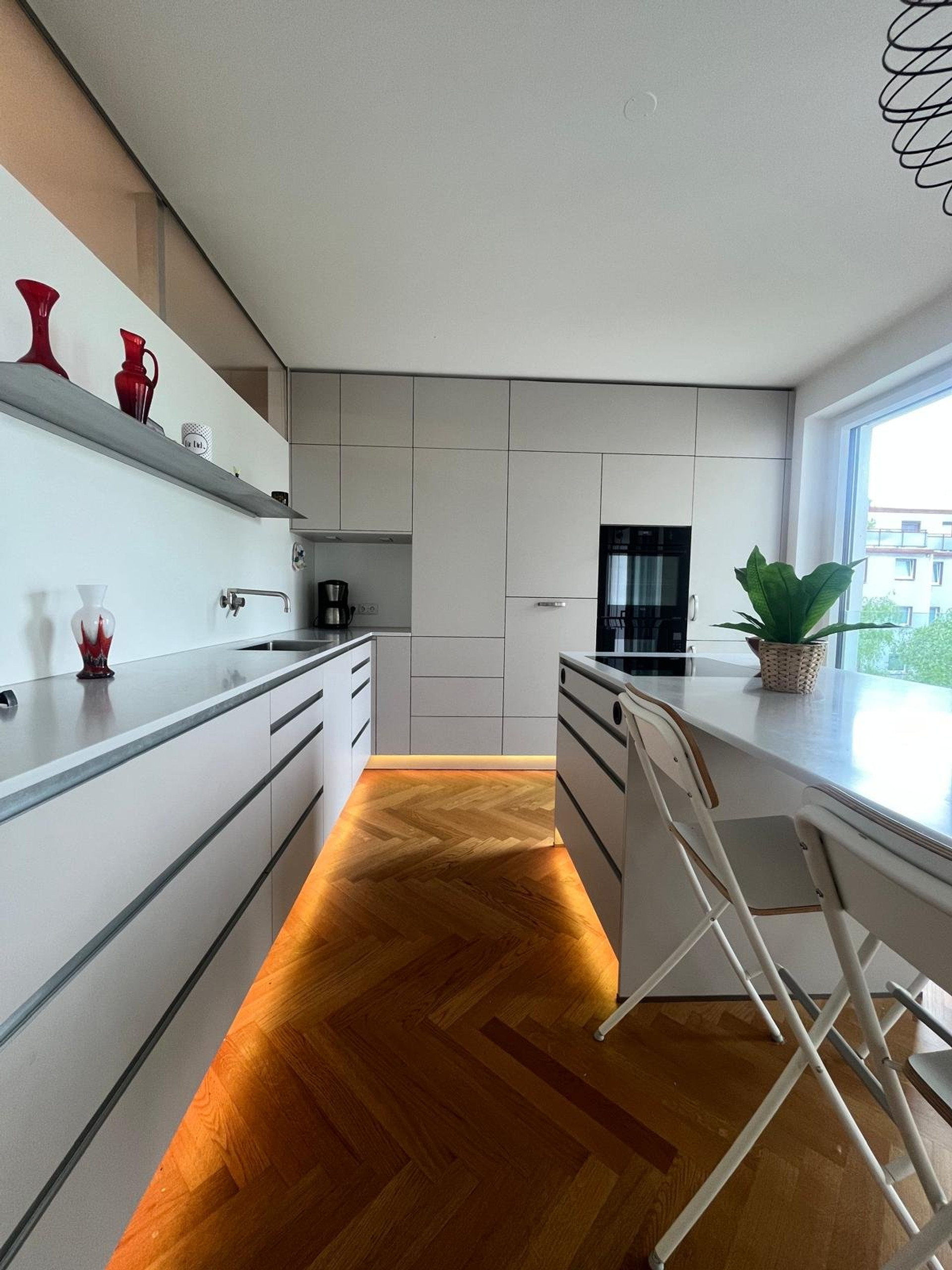 Sleek white kitchen with lighting