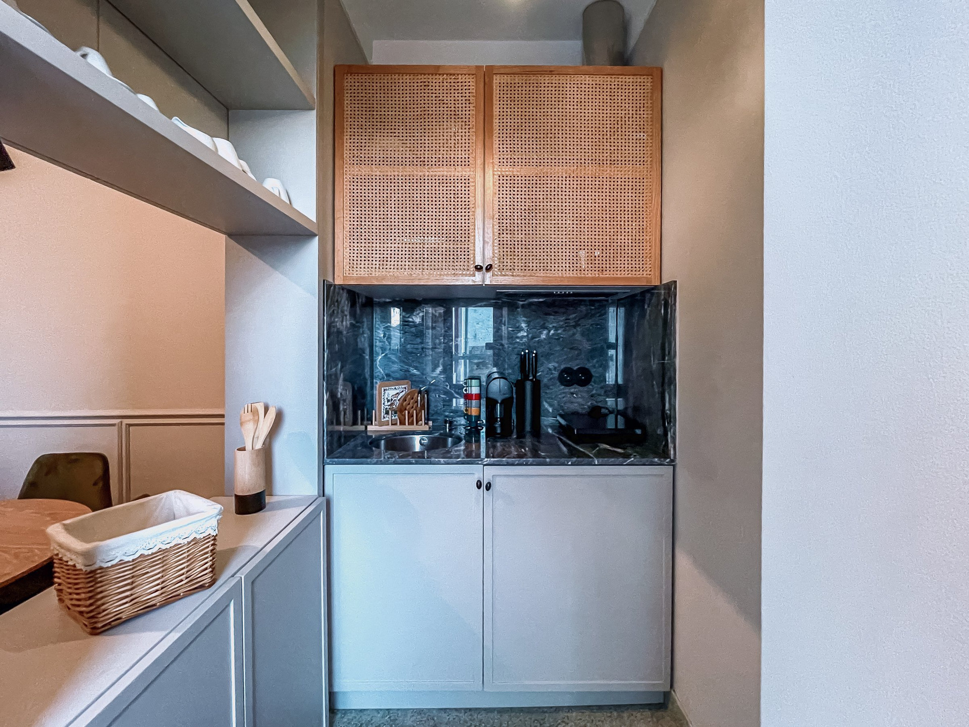 Kitchenette with rattan cabinets